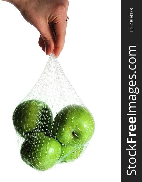 Hand holding a pack of green apples, isolated on white. Hand holding a pack of green apples, isolated on white