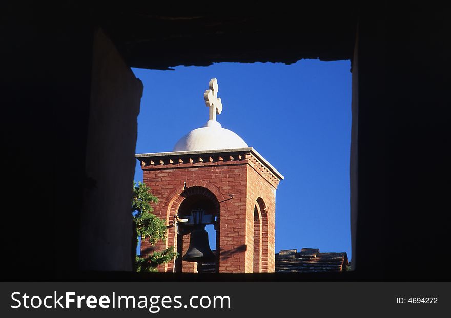 A tower church through a window. A tower church through a window