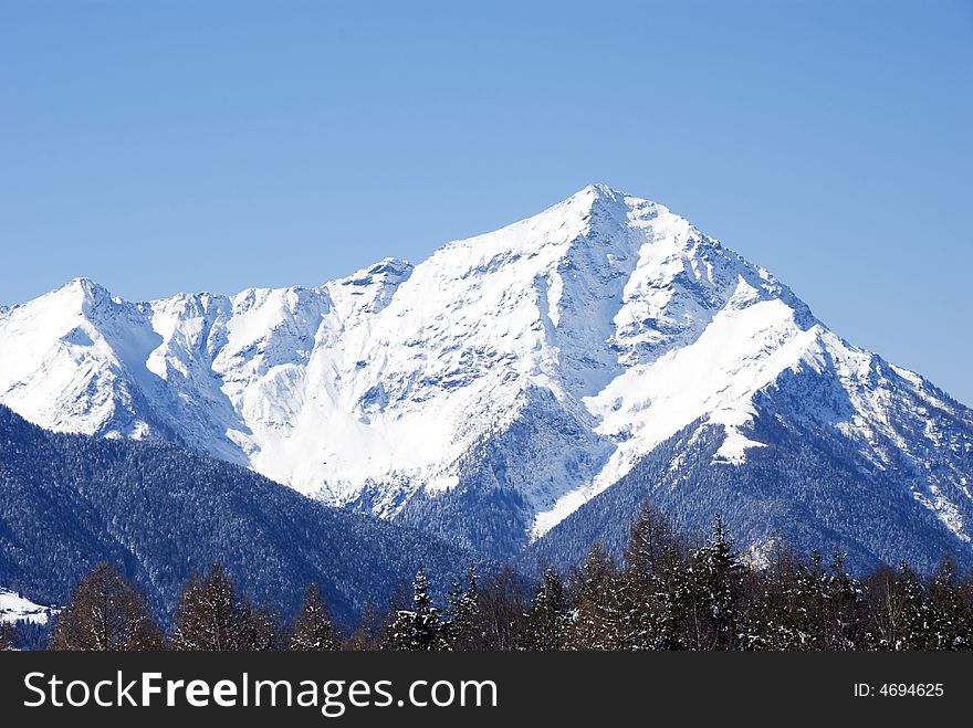 A close up of Legnone mountain after a snowfall - in italian Alps - in blue light. A close up of Legnone mountain after a snowfall - in italian Alps - in blue light