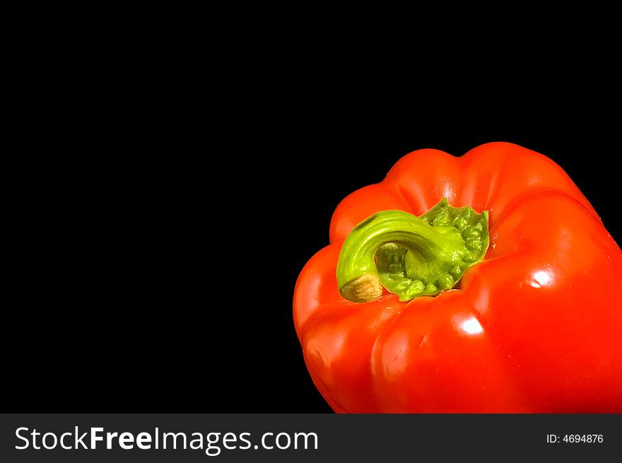 Single red Bell Pepper on a black background