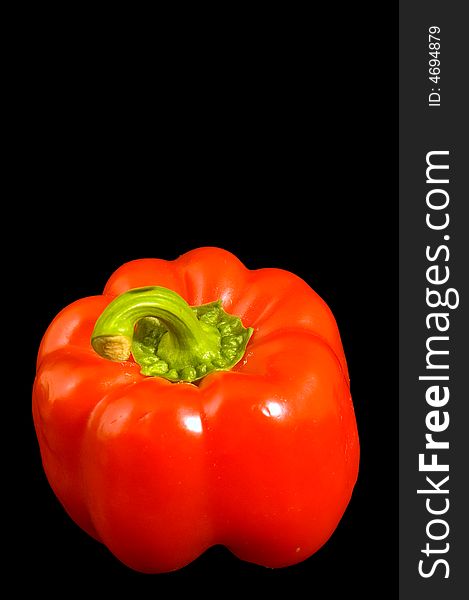 Single red Bell Pepper on a black background