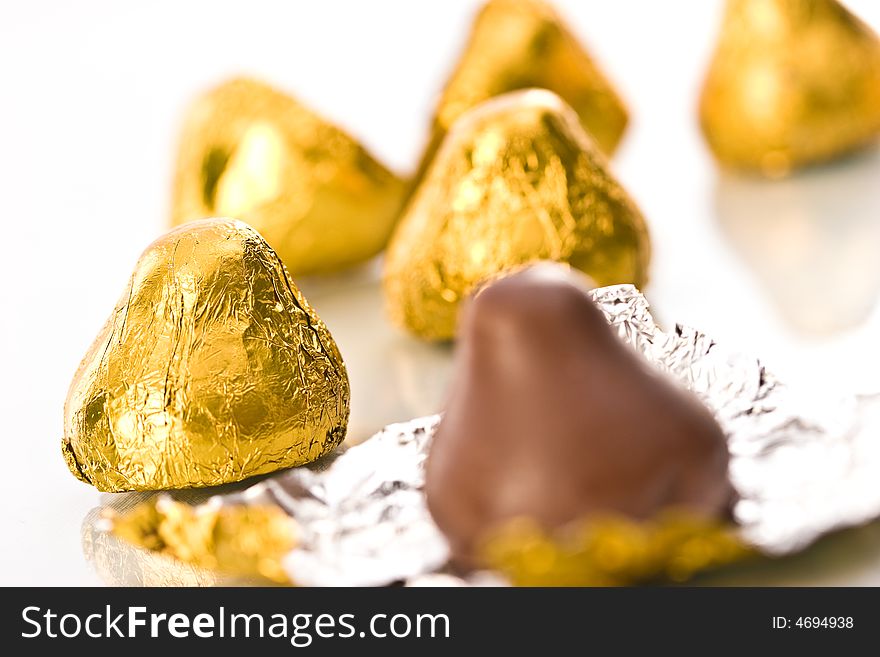 Sweet, chocolate candy on the golden foil