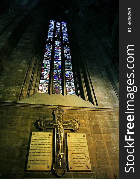 A cross under stained-glass window