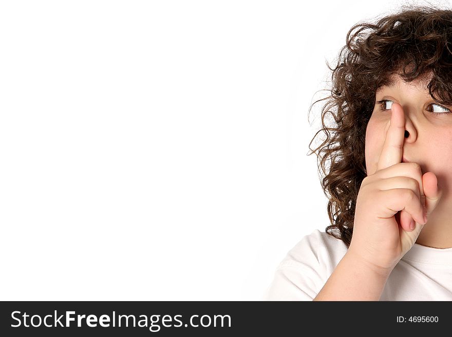 Boy gestures for silence on white background