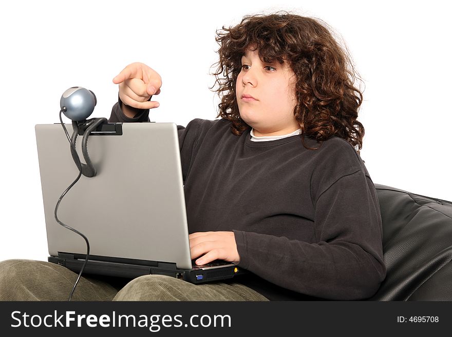 Boy using laptop and webcam on white background