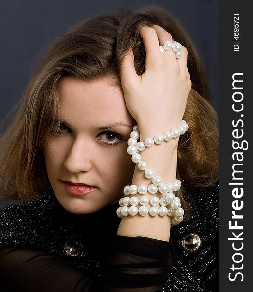 Retro-styled girl with beads on hand