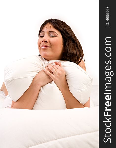 Cute girl in bed hugging her pillow. Cute girl in bed hugging her pillow