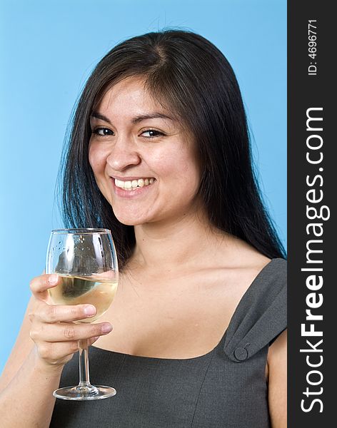A laughing, pretty young woman holding a wine glass with liquid in it. A laughing, pretty young woman holding a wine glass with liquid in it.