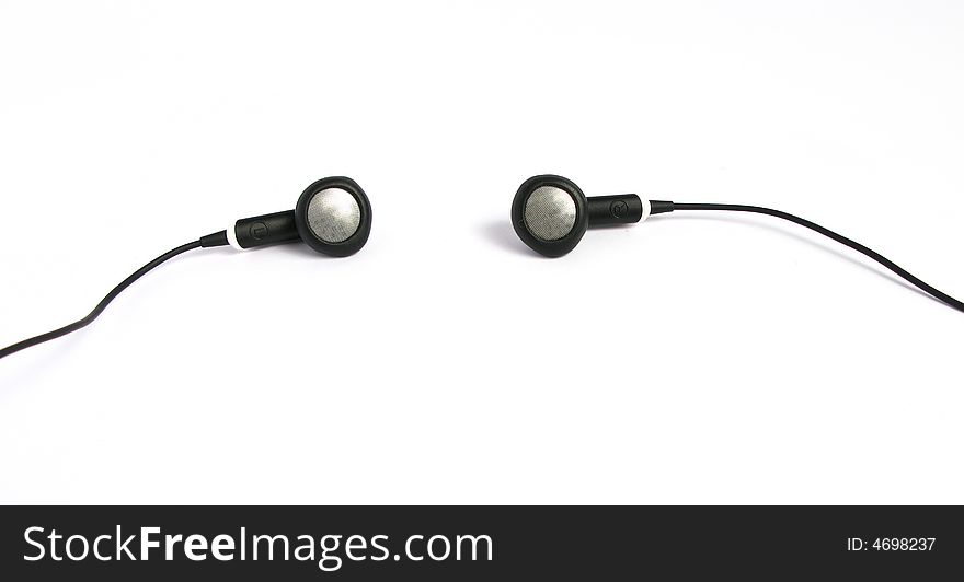 Small metallic and rubber headphones in a white background. Small metallic and rubber headphones in a white background.