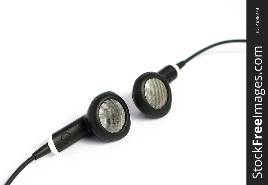 Small metallic and rubber headphones in a white background. Small metallic and rubber headphones in a white background.