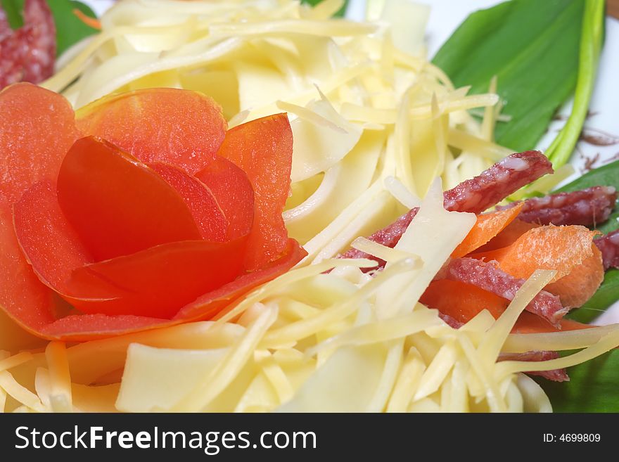 Pasta with cheese, salami, tomatoes and herbs on a white plate (Shallow deep of field)