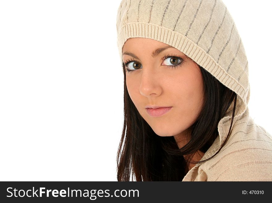 Beautiful young woman in hooded sweater over white. Shot in studio.