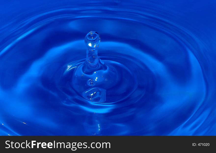 Water drop captured on impact with the still water surface