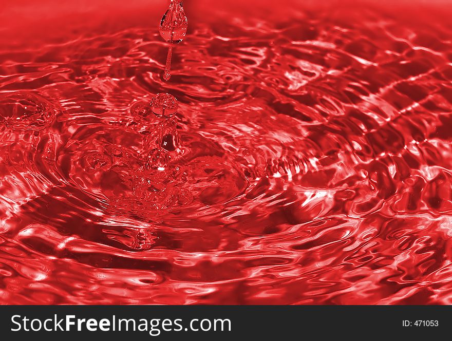 Water drop captured on impact with the still water surface