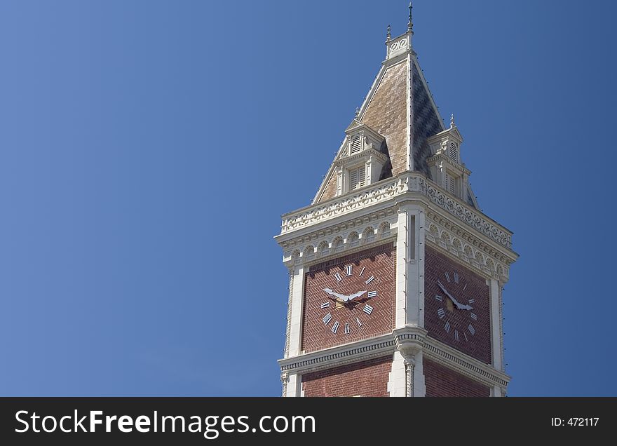 An old clocktower set against a late-afternoon blue sky. An old clocktower set against a late-afternoon blue sky.