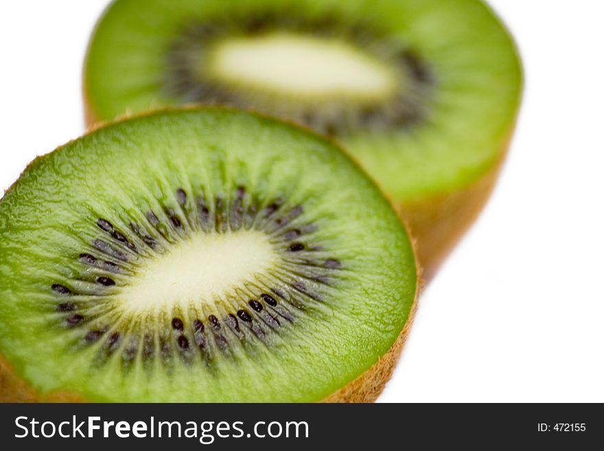 Close up on a sliced kiwi fruit on a white background. Close up on a sliced kiwi fruit on a white background.