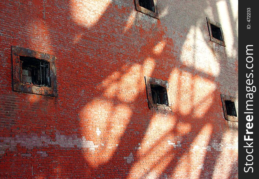 The wall of a brick fort with shadows cast by the Golden Gate bridge in San Francisco. The wall of a brick fort with shadows cast by the Golden Gate bridge in San Francisco