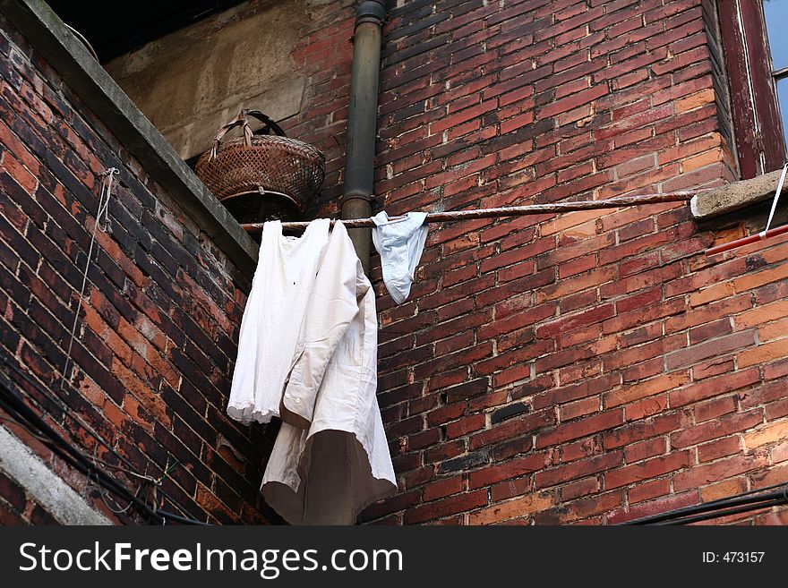 Laundry hanging at corner of building