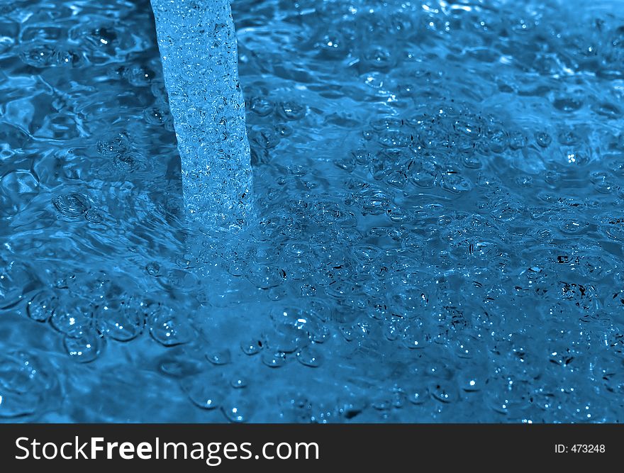 Water flow captured on impact with the still water surface