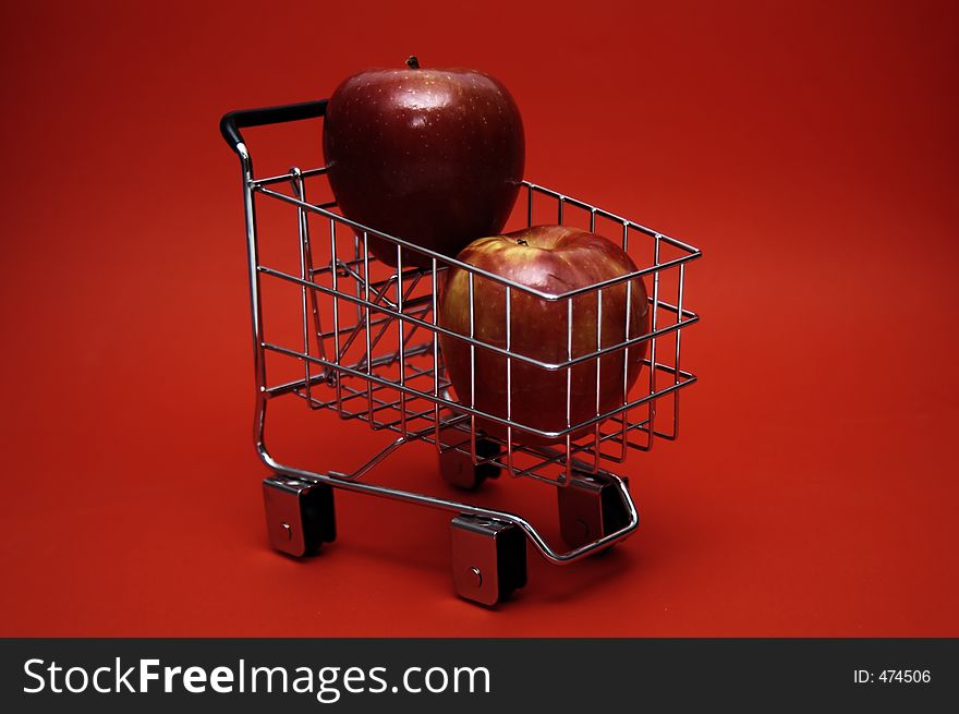 Juicy red apples stacked in a shopping cart. Juicy red apples stacked in a shopping cart.
