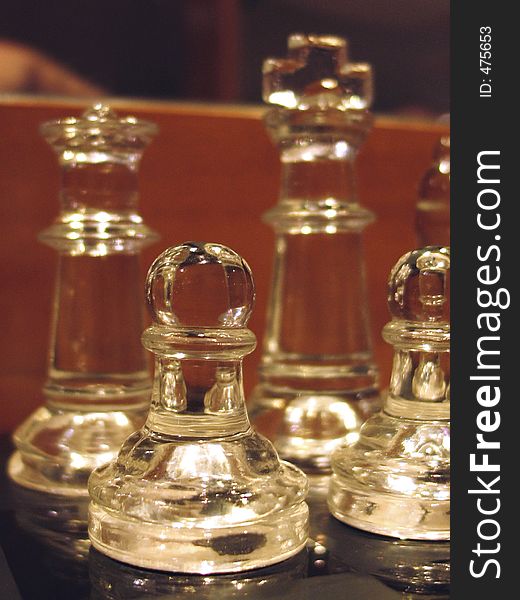 Crystal chess pieces featuring a pawn in the foreground. Crystal chess pieces featuring a pawn in the foreground