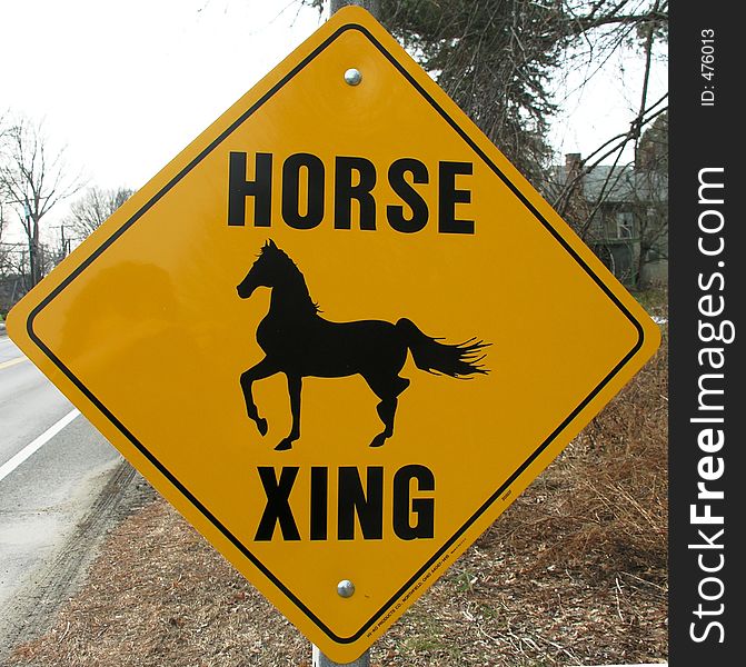 Horse crossing sign on a rural road. Horse crossing sign on a rural road.