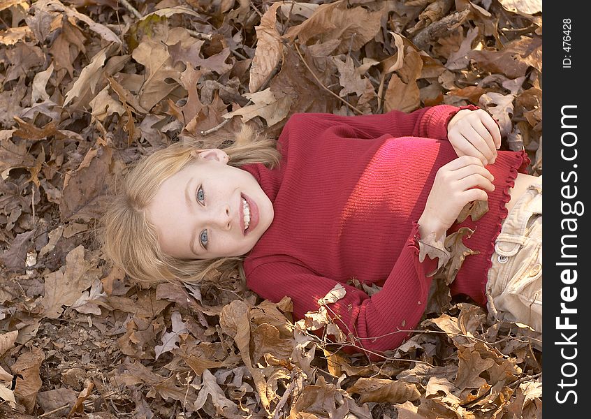 Girl laying in leaves. Girl laying in leaves