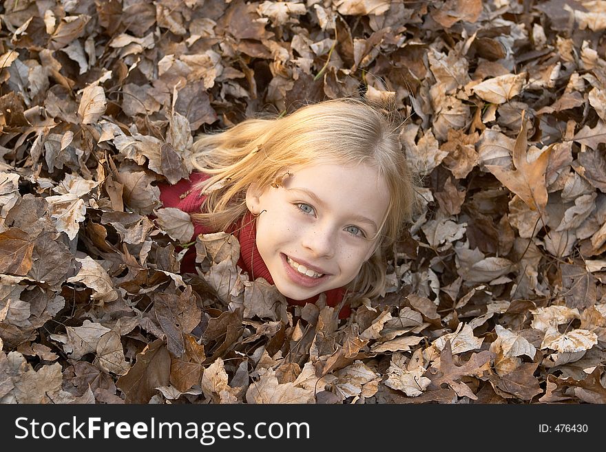 Girl playing in leaves. Girl playing in leaves