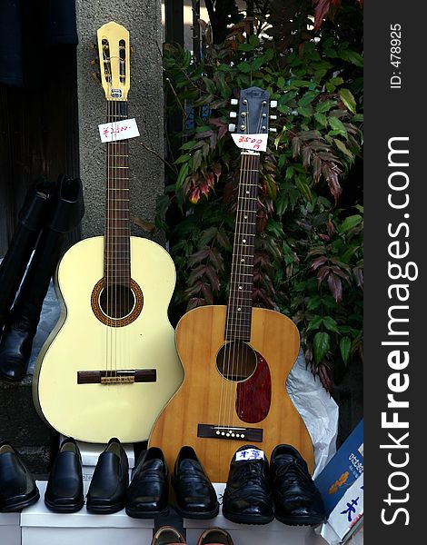 Two guitars and some shoes pairs for sale
