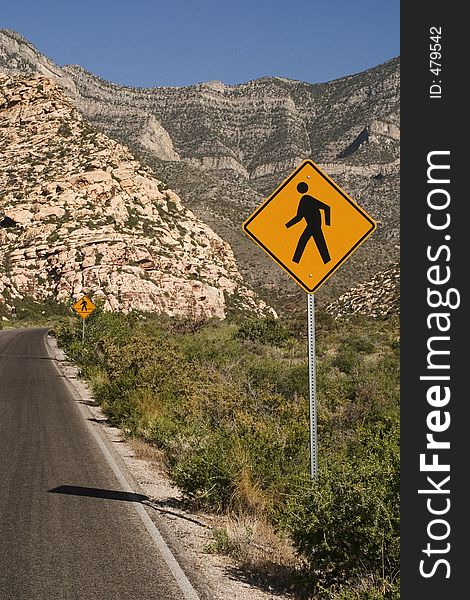 Pedestrian crossing caution sign on a western roadway. Pedestrian crossing caution sign on a western roadway