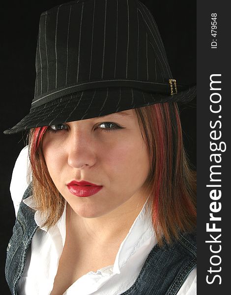 Beautiful young woman with a black hat on her head and a sneer on her face. Shot with a Canon 20D. Beautiful young woman with a black hat on her head and a sneer on her face. Shot with a Canon 20D.