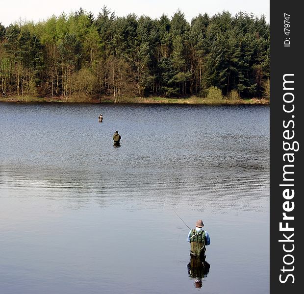Row of anglers in Fenistone reservoir, Yorkshire, UK. Row of anglers in Fenistone reservoir, Yorkshire, UK