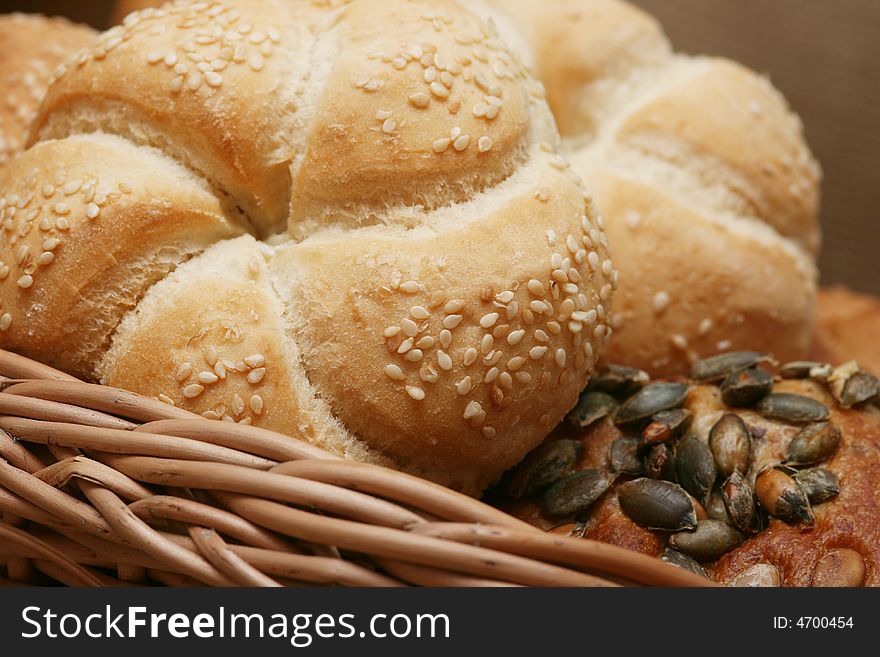 A closeup of a different bread with wheat grains and stalks placed next to it. A closeup of a different bread with wheat grains and stalks placed next to it.