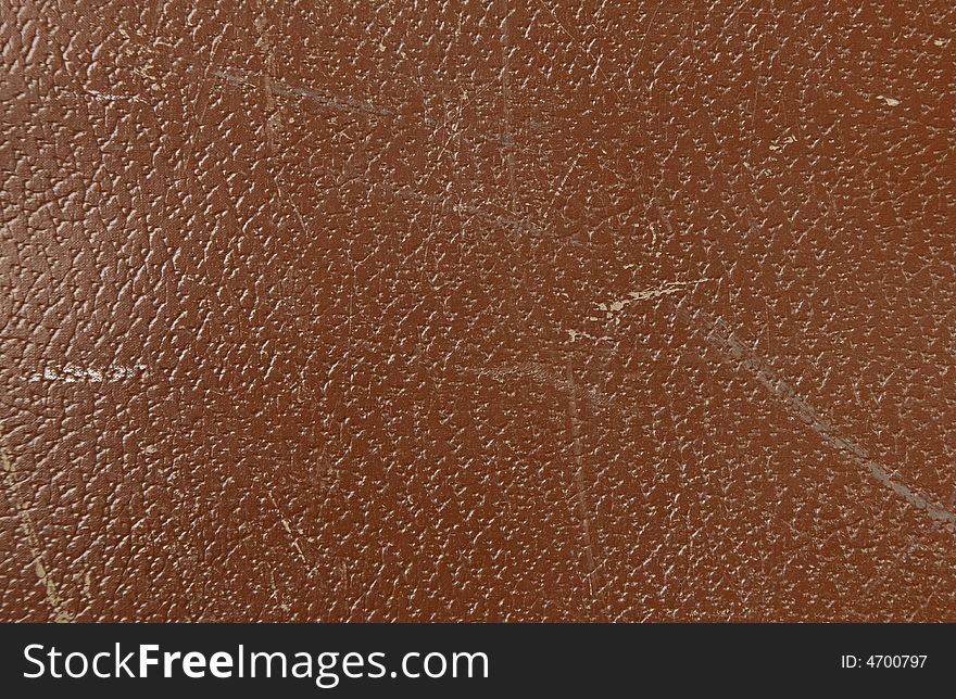 Brown leather texture with visible wear and tear. Brown leather texture with visible wear and tear