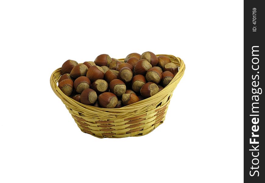 Nuts in wattled basket isolated on white. Nuts in wattled basket isolated on white