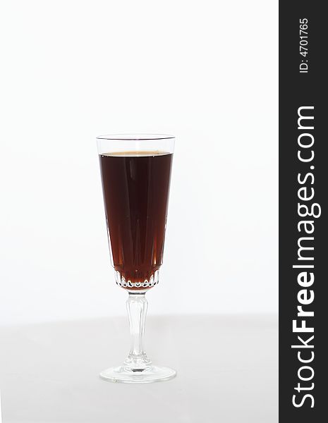 A glass of red wine against a light background