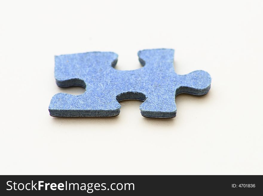 Blue piece of jigsaw puzzle over   white background. Blue piece of jigsaw puzzle over   white background
