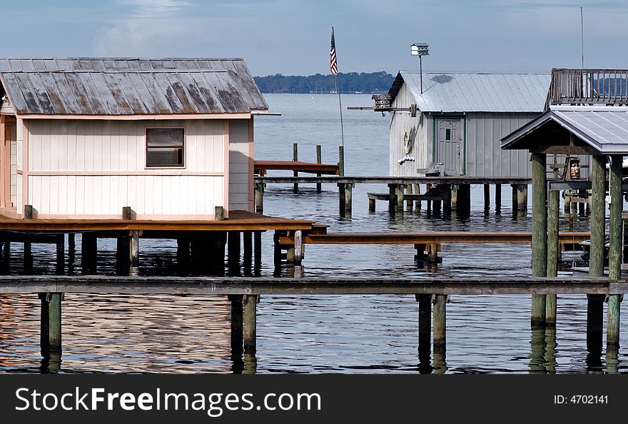 Portions of dock houses and boat shelters over water.