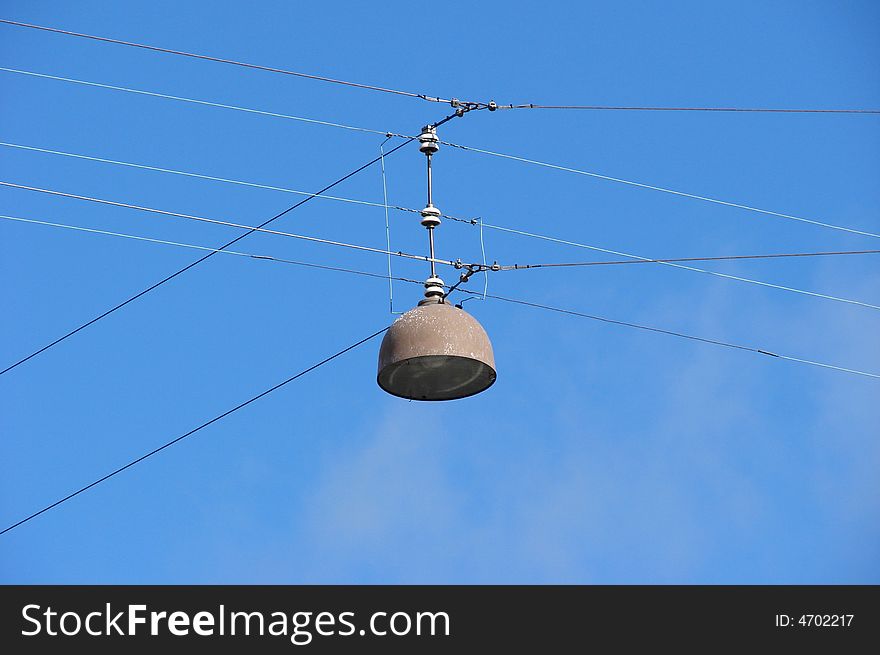 Hanging street lamp with a blue sky