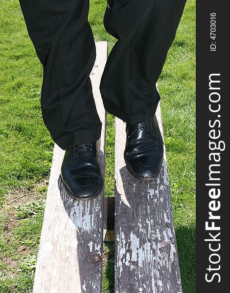 Close-up of single man standing on park bench. Close-up of single man standing on park bench