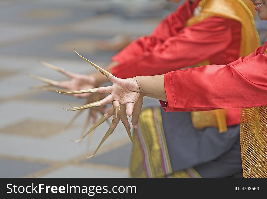 In a traditional Thai dance performance, the dancers long artificial fingernails