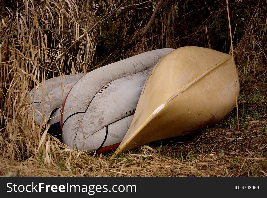 Abandonded canoe and rafts in a marshy area. Abandonded canoe and rafts in a marshy area