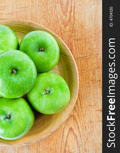 Green apples in a wooden bowl. Green apples in a wooden bowl