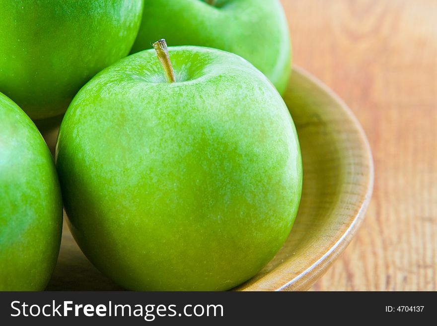 Green apples in a wooden bowl. Green apples in a wooden bowl