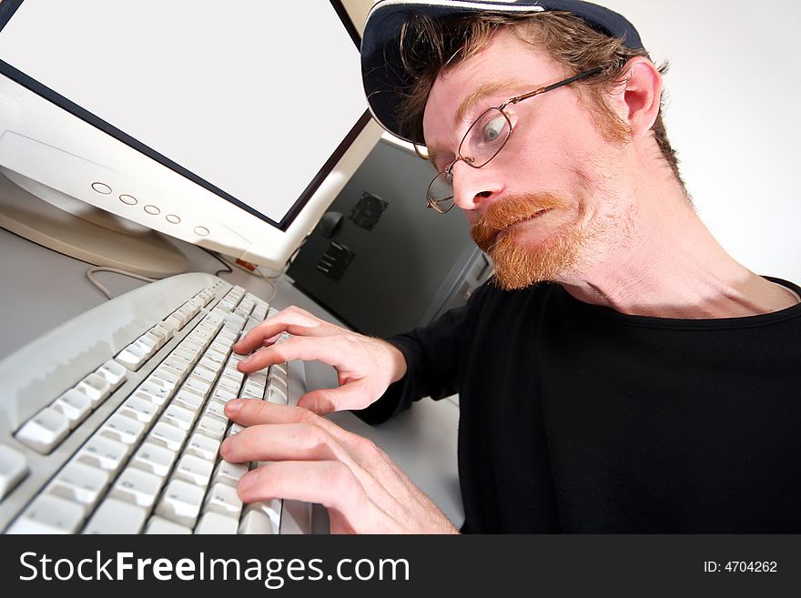Mad programmer sitting at a computer desk
