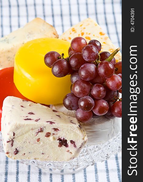 Cheese and grape selection on a blue and white cloth