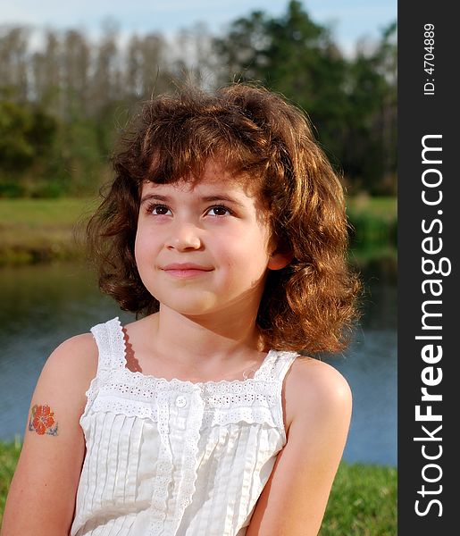 The close up of a cute girl with brown eyes and curly hair. The close up of a cute girl with brown eyes and curly hair