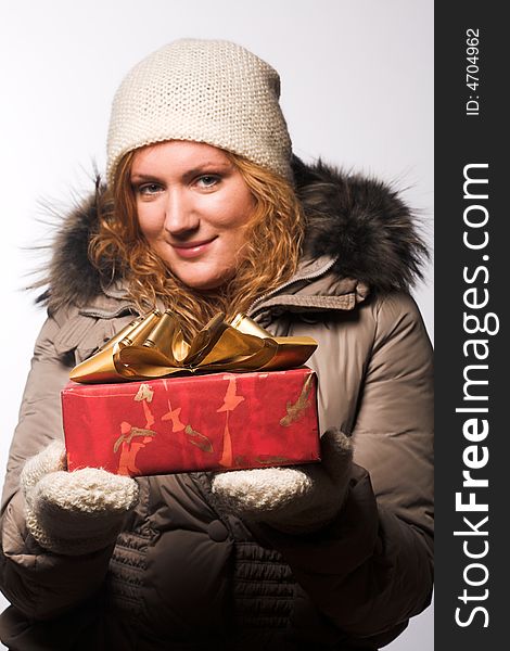 Beautiful woman offering a christmas gift