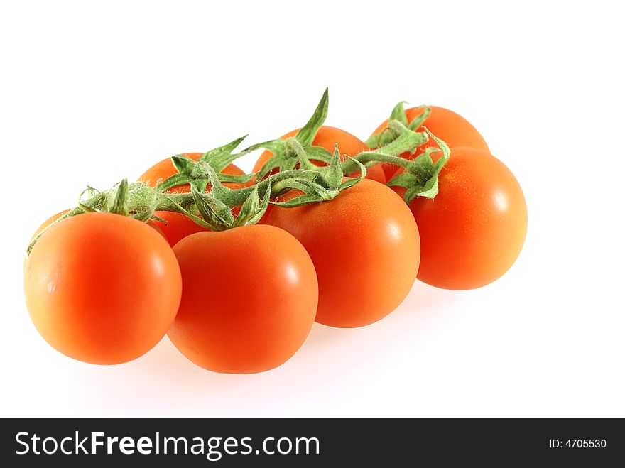 Small fresh juicy tomatos on the white background