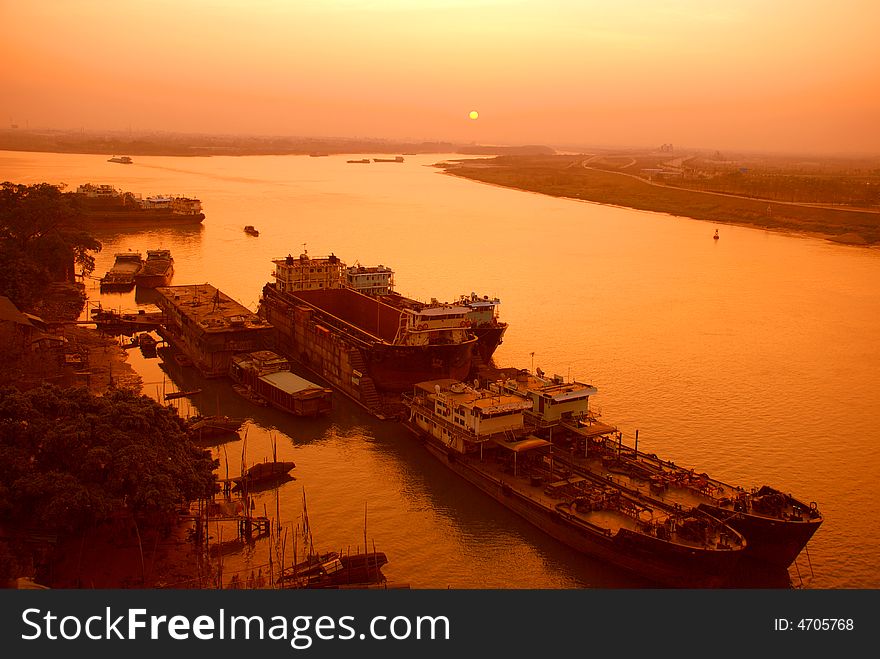 A small inland river city port in the sunrise, a port at the converging place of two rivulet Foshan,guangdong,China. A small inland river city port in the sunrise, a port at the converging place of two rivulet Foshan,guangdong,China.